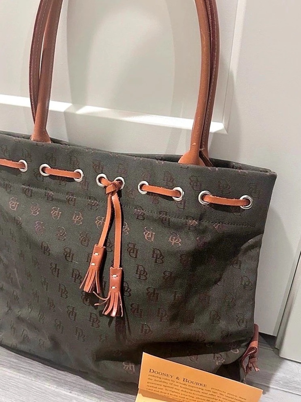 Dooney & Bourke signature canvas tassel tote bag with leather trim